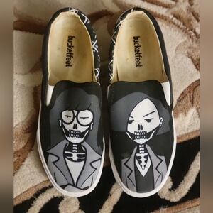 Daria and Jane black/white skeleton slip ons